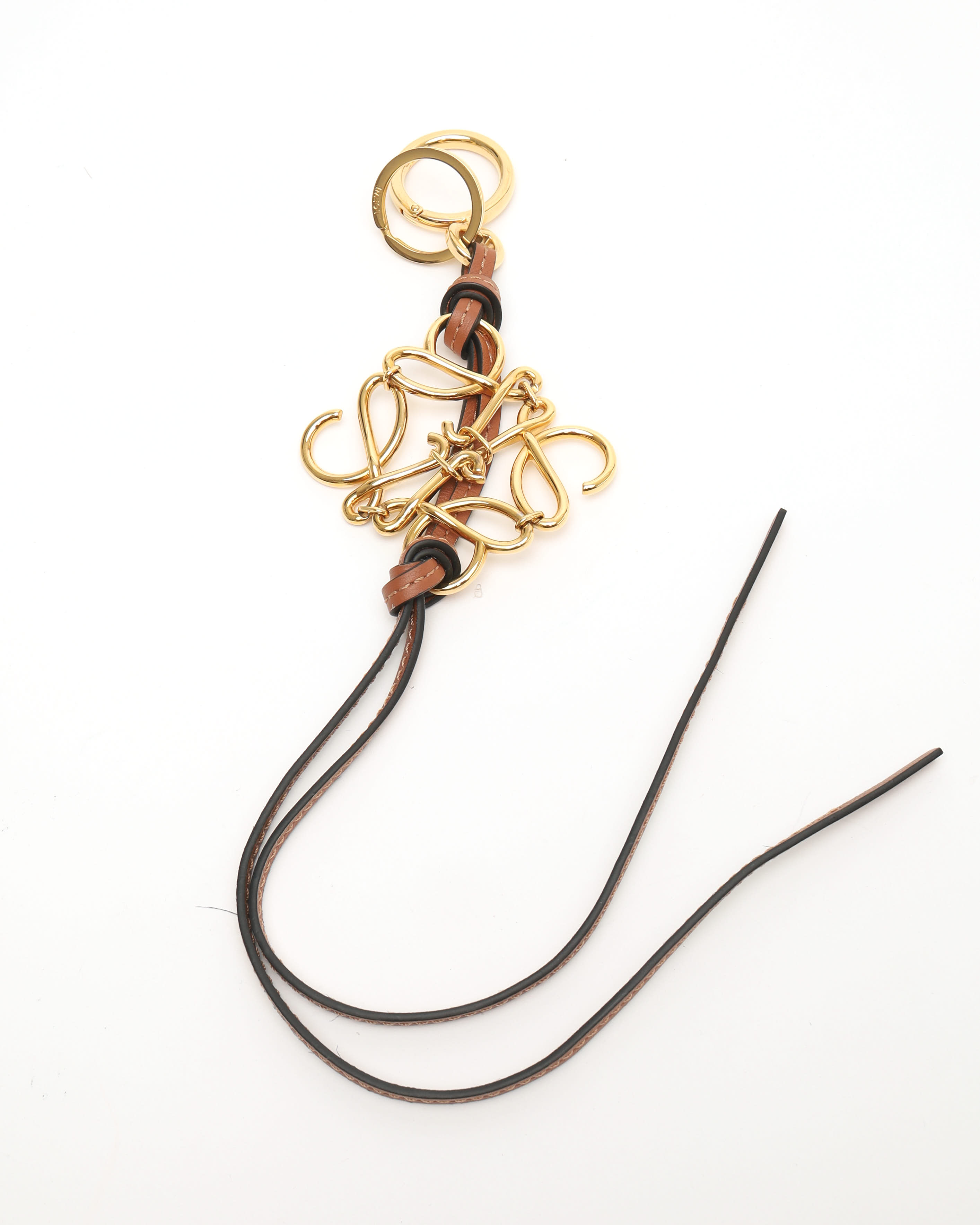 Loewe Anagram Charm In A Gold Finish On A Calfskin Strap In Gold
