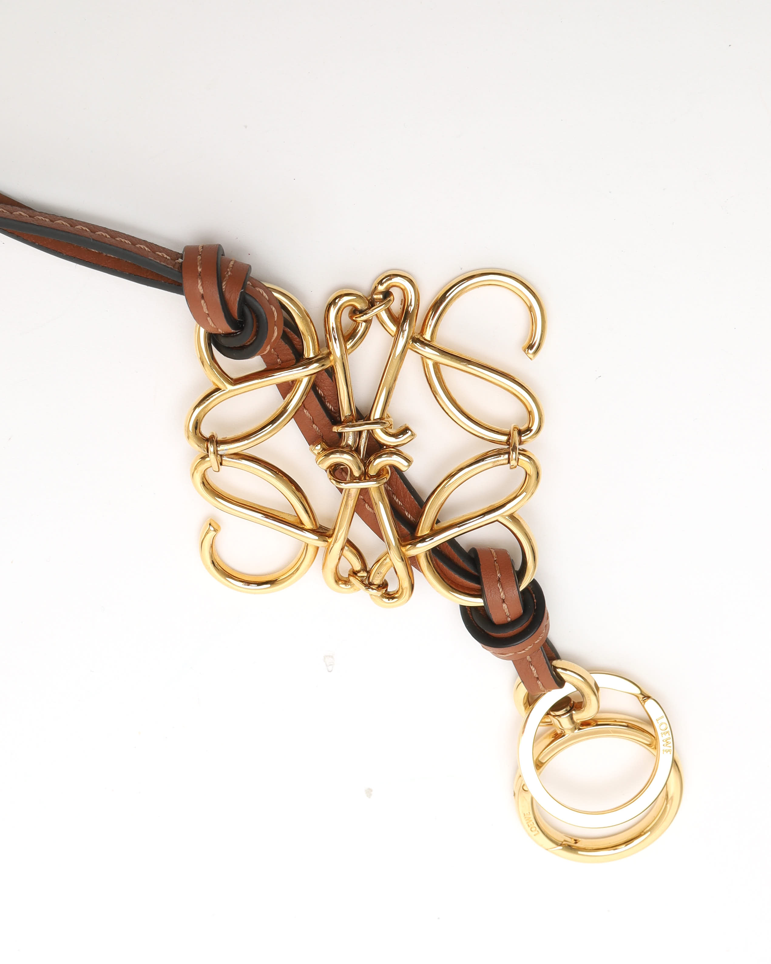 Loewe Anagram Charm In A Gold Finish On A Calfskin Strap In Gold