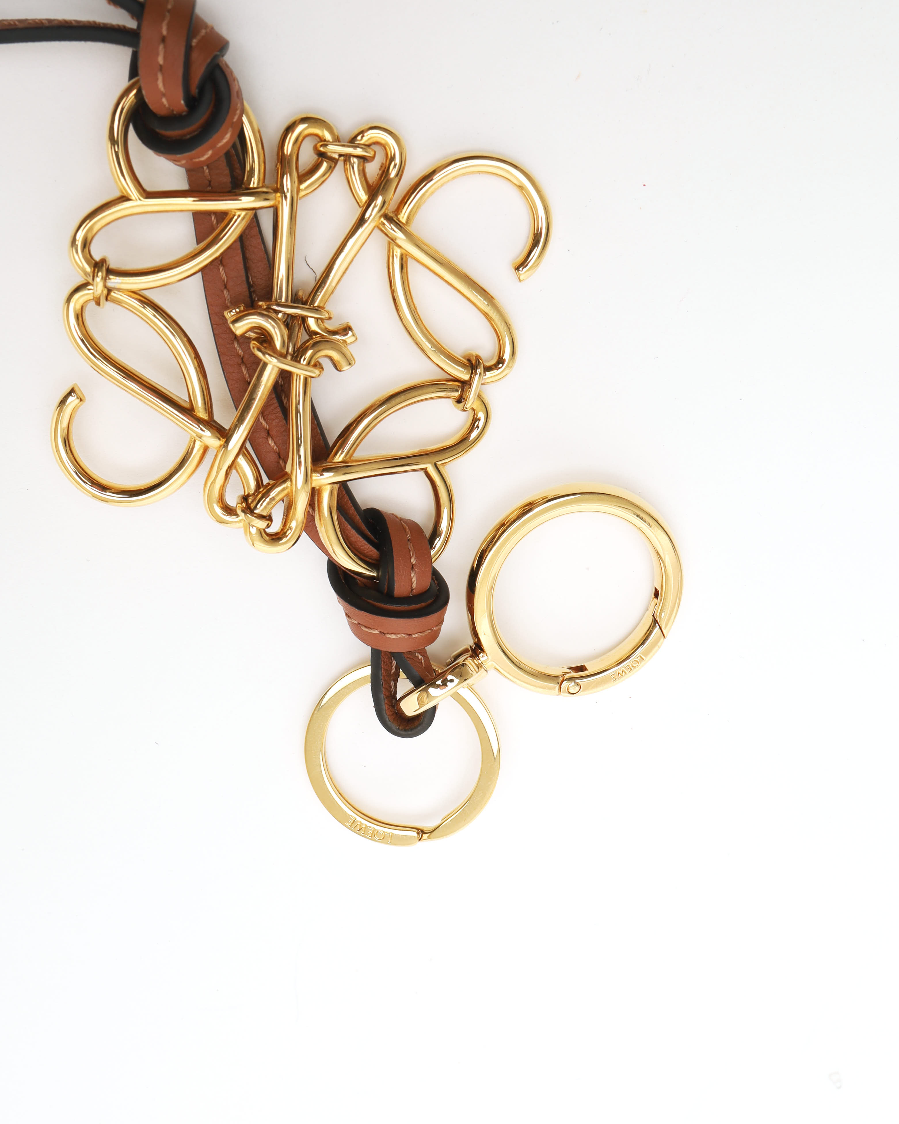 Loewe Anagram Charm In A Gold Finish On A Calfskin Strap In Gold