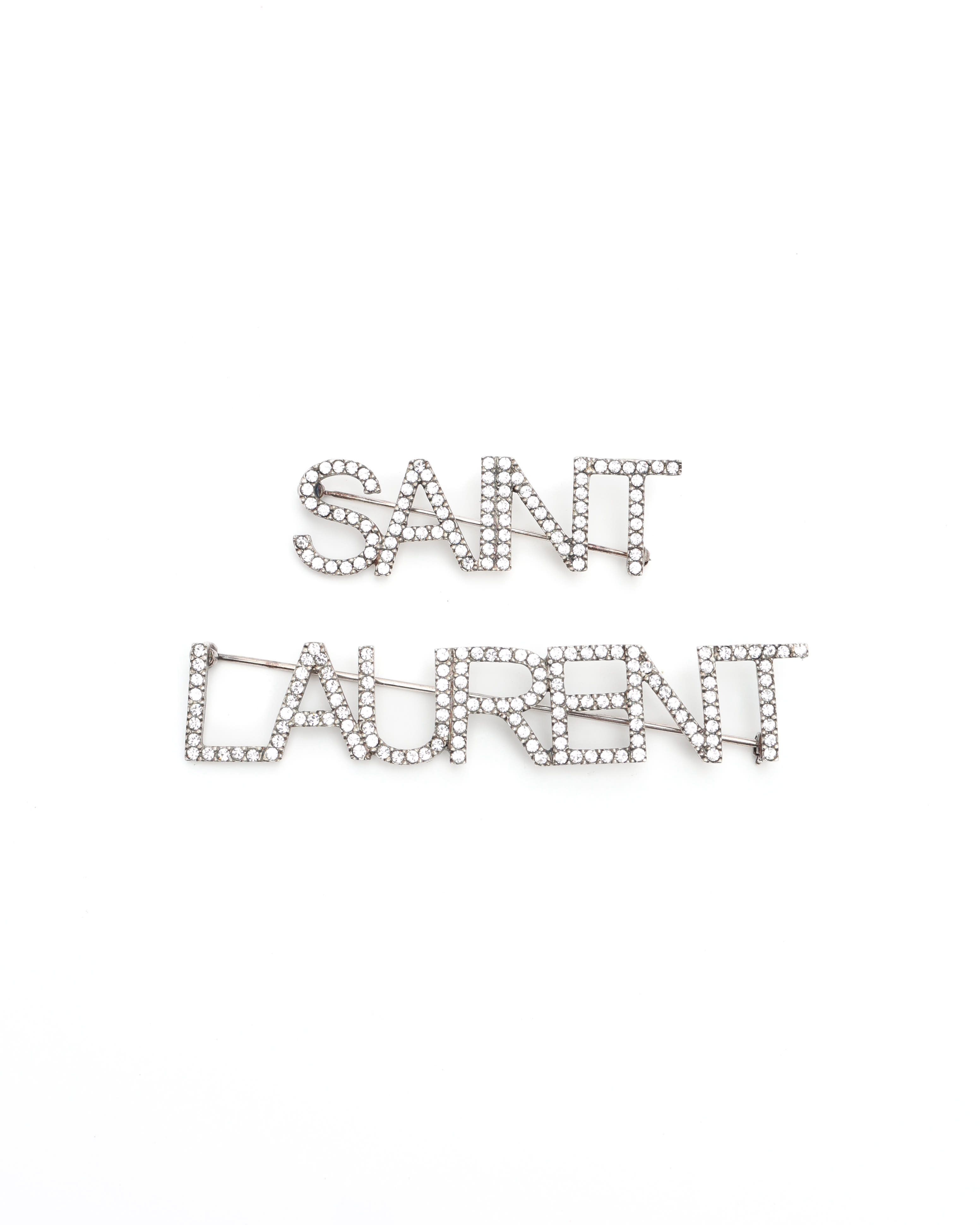 Saint Laurent Logo Rhinestone Brooch In Metallic